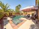 Relaxing outdoor pool and patio area with comfortable seating and tropical landscaping at 2382 Sunburst View St, Henderson, NV 89052