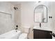 Stylish bathroom with white tiled shower, modern vanity, and sleek black fixtures at 239 Concho Dr, Henderson, NV 89015