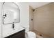 Contemporary bathroom showcasing a floating vanity, sleek mirror, and tiled walk-in shower at 239 Concho Dr, Henderson, NV 89015