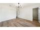 Bright bedroom with hardwood floors, modern lighting, and access to an ensuite bathroom at 239 Concho Dr, Henderson, NV 89015