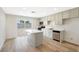Bright and airy kitchen featuring modern appliances, island, and direct access to the backyard at 239 Concho Dr, Henderson, NV 89015