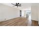 Spacious room with wood floors, ceiling fan, and an open layout to the kitchen area at 239 Concho Dr, Henderson, NV 89015