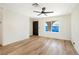 Inviting living room featuring wood floors, a ceiling fan, and a large window at 239 Concho Dr, Henderson, NV 89015