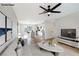 Bright living room showcasing wood floors, modern ceiling fan, and open floor plan to the adjacent kitchen at 239 Concho Dr, Henderson, NV 89015