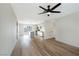Open-concept room with wood-look flooring, ceiling fan, and seamless flow to the kitchen at 239 Concho Dr, Henderson, NV 89015