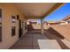 Covered back patio features concrete pavers, privacy wall, and sliding glass door at 240 Vineyard Ln, Mesquite, NV 89027