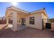 Exterior side view of back yard with covered patio, xeriscape landscape and stucco wall at 240 Vineyard Ln, Mesquite, NV 89027