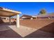 The backyard offers a covered patio, concrete floor, privacy wall and desert landscaping at 240 Vineyard Ln, Mesquite, NV 89027