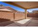 Backyard with covered patio, gravel landscaping, and block wall perimeter at 240 Vineyard Ln, Mesquite, NV 89027