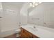 Well-lit bathroom featuring a white vanity, toilet, shower, and bathtub combination at 240 Vineyard Ln, Mesquite, NV 89027
