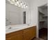 Bathroom with double sink vanity, a mirror, and a door way into a walk-in closet at 240 Vineyard Ln, Mesquite, NV 89027