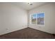 Bright bedroom with a large window, carpet floors, and white walls, creating a serene atmosphere at 240 Vineyard Ln, Mesquite, NV 89027