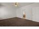 Neutral bedroom with carpeting, ceiling fan, and doorway leading to bathroom at 240 Vineyard Ln, Mesquite, NV 89027