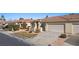 View of the front exterior with desert landscaping, and a two-car garage at 240 Vineyard Ln, Mesquite, NV 89027