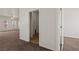 Hallway with neutral walls and flooring leads to additional rooms, offering easy navigation throughout the home at 240 Vineyard Ln, Mesquite, NV 89027