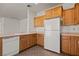Bright kitchen featuring tile flooring, wood cabinets, and white appliances at 240 Vineyard Ln, Mesquite, NV 89027