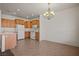 Kitchen featuring oak cabinets, tile flooring, and white appliances at 240 Vineyard Ln, Mesquite, NV 89027