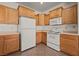 Cozy kitchen features tile flooring, wood cabinetry, and white appliances at 240 Vineyard Ln, Mesquite, NV 89027
