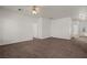 Neutral living room with brown carpet featuring an open doorway and white walls at 240 Vineyard Ln, Mesquite, NV 89027