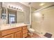 Bathroom featuring light wood cabinets, shower, and laminate floors at 2509 Banora Point Dr, Las Vegas, NV 89134