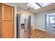 Kitchen featuring stainless steel refrigerator, light wood cabinetry, and skylight at 2509 Banora Point Dr, Las Vegas, NV 89134