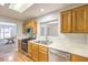 Kitchen features stainless steel appliances, light wood cabinetry, and view to living room at 2509 Banora Point Dr, Las Vegas, NV 89134