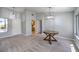 Open-concept living room with modern pendant lighting, neutral paint, and large windows at 2509 Banora Point Dr, Las Vegas, NV 89134