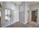 Open-concept living room with modern pendant lighting, neutral paint, and large windows at 2509 Banora Point Dr, Las Vegas, NV 89134
