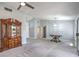 Spacious living room featuring neutral walls, carpeted floors, and modern lighting fixtures at 2509 Banora Point Dr, Las Vegas, NV 89134