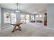 Spacious living room with new carpet, ceiling fan, and sliding door to backyard at 2509 Banora Point Dr, Las Vegas, NV 89134