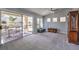 Spacious living room with new carpet, ceiling fan, and sliding door to backyard at 2509 Banora Point Dr, Las Vegas, NV 89134