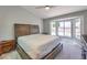Main bedroom featuring a king bed, ceiling fan, and bay window overlooking the yard at 2509 Banora Point Dr, Las Vegas, NV 89134