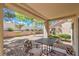 Cozy covered patio with outdoor seating and a view of the private, landscaped backyard at 2509 Banora Point Dr, Las Vegas, NV 89134