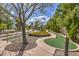 Scenic putting green area winding through mature landscaping, offering a relaxing recreational space at 2509 Banora Point Dr, Las Vegas, NV 89134