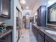 Luxurious bathroom featuring double sinks, granite countertops and glass block shower at 2521 Seascape Dr, Las Vegas, NV 89128