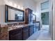 Luxurious bathroom with double sinks, granite countertops and dark wood cabinets at 2521 Seascape Dr, Las Vegas, NV 89128