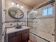 Well-lit bathroom with an updated sink and cabinet, along with a tile-lined shower and tub at 2521 Seascape Dr, Las Vegas, NV 89128