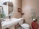 Well-appointed powder room featuring a pedestal sink, decorative mirror, and elegant decor for a touch of sophistication at 2521 Seascape Dr, Las Vegas, NV 89128
