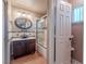 Well-lit bathroom with updated sink and cabinet, along with tile-lined shower and tub at 2521 Seascape Dr, Las Vegas, NV 89128