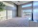 Spacious bedroom with high ceilings, large windows, and access to a private balcony overlooking serene outdoor views at 2521 Seascape Dr, Las Vegas, NV 89128