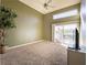 Bright bedroom featuring a ceiling fan and sliding glass doors to the backyard at 2521 Seascape Dr, Las Vegas, NV 89128