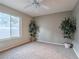 Cozy bedroom with neutral paint and carpet, and a ceiling fan at 2521 Seascape Dr, Las Vegas, NV 89128
