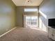 Bright bedroom with a ceiling fan and sliding glass door at 2521 Seascape Dr, Las Vegas, NV 89128