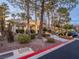 Community clubhouse with a covered entrance, landscaping, and ample parking at 2521 Seascape Dr, Las Vegas, NV 89128