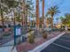 Community pool area, surrounded by lush landscaping and secured by a wrought iron fence at 2521 Seascape Dr, Las Vegas, NV 89128