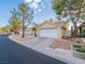 Single-story home with two-car garage and desert landscaping for easy maintenance at 2521 Seascape Dr, Las Vegas, NV 89128