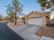 Charming single-story home featuring a two-car garage and a well-maintained landscaped front yard at 2521 Seascape Dr, Las Vegas, NV 89128
