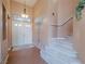 Inviting foyer with a charming staircase and a decorative palm tree mural for a unique touch at 2521 Seascape Dr, Las Vegas, NV 89128