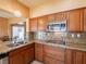 Charming kitchen with granite countertops, stainless steel appliances, and a convenient gas cooktop for gourmet cooking at 2521 Seascape Dr, Las Vegas, NV 89128