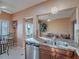 Bright kitchen featuring granite countertops, stainless steel appliances, and an adjacent breakfast nook with outdoor views at 2521 Seascape Dr, Las Vegas, NV 89128